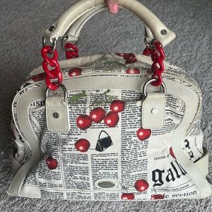 John Galliano large handbag. Cherry over newspaper print.
